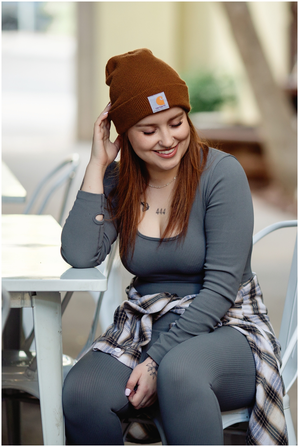 A candid photo of a girl with red hair sitting outside of a Buckeye, Arizona coffee shop.