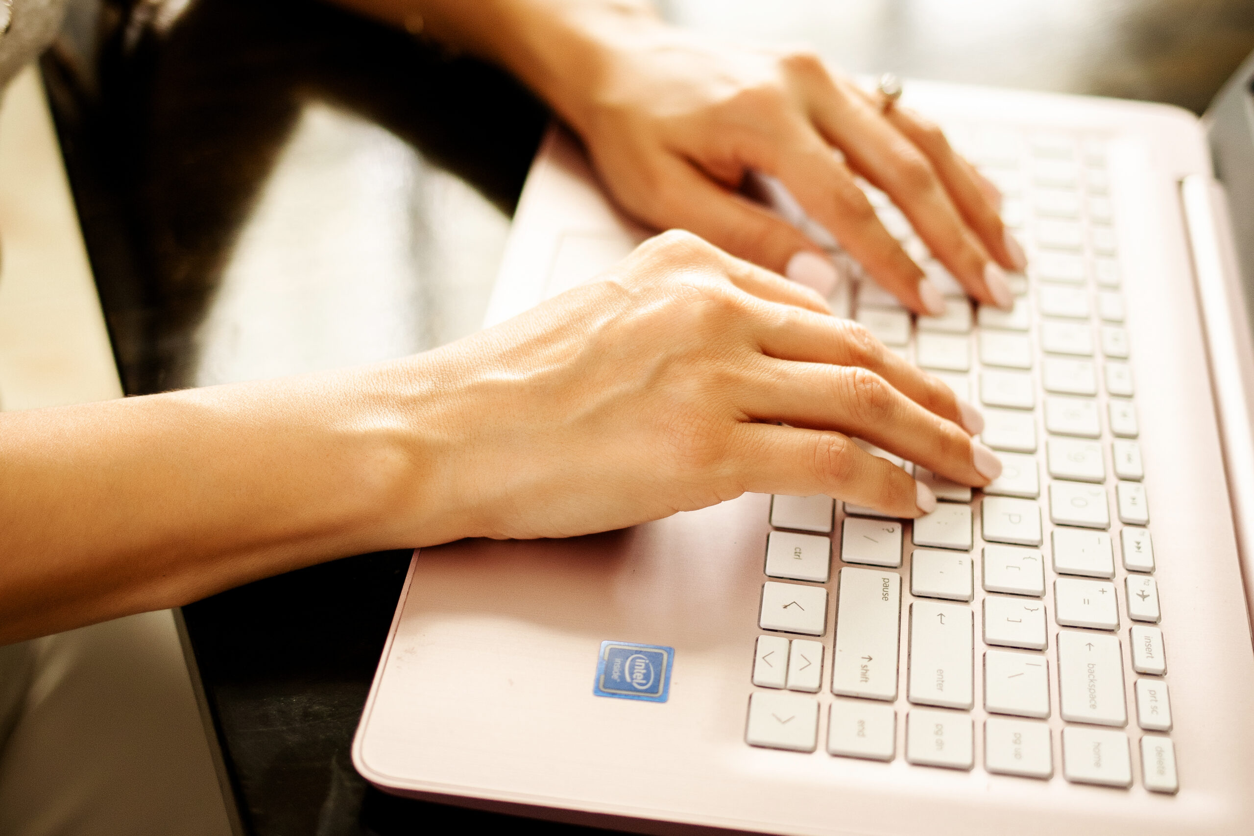 Woman hands typing on laptop